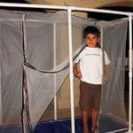 Andrei showing off his Black Soldier fly nursery enclosure built from mosquito net and PVC pipe.